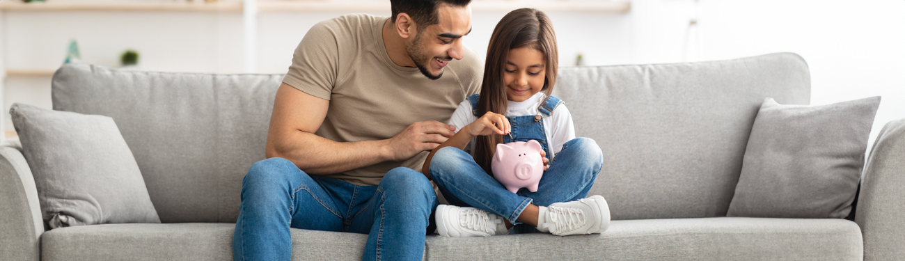 dad and daughter with piggy bank dad and daughter with piggy bank